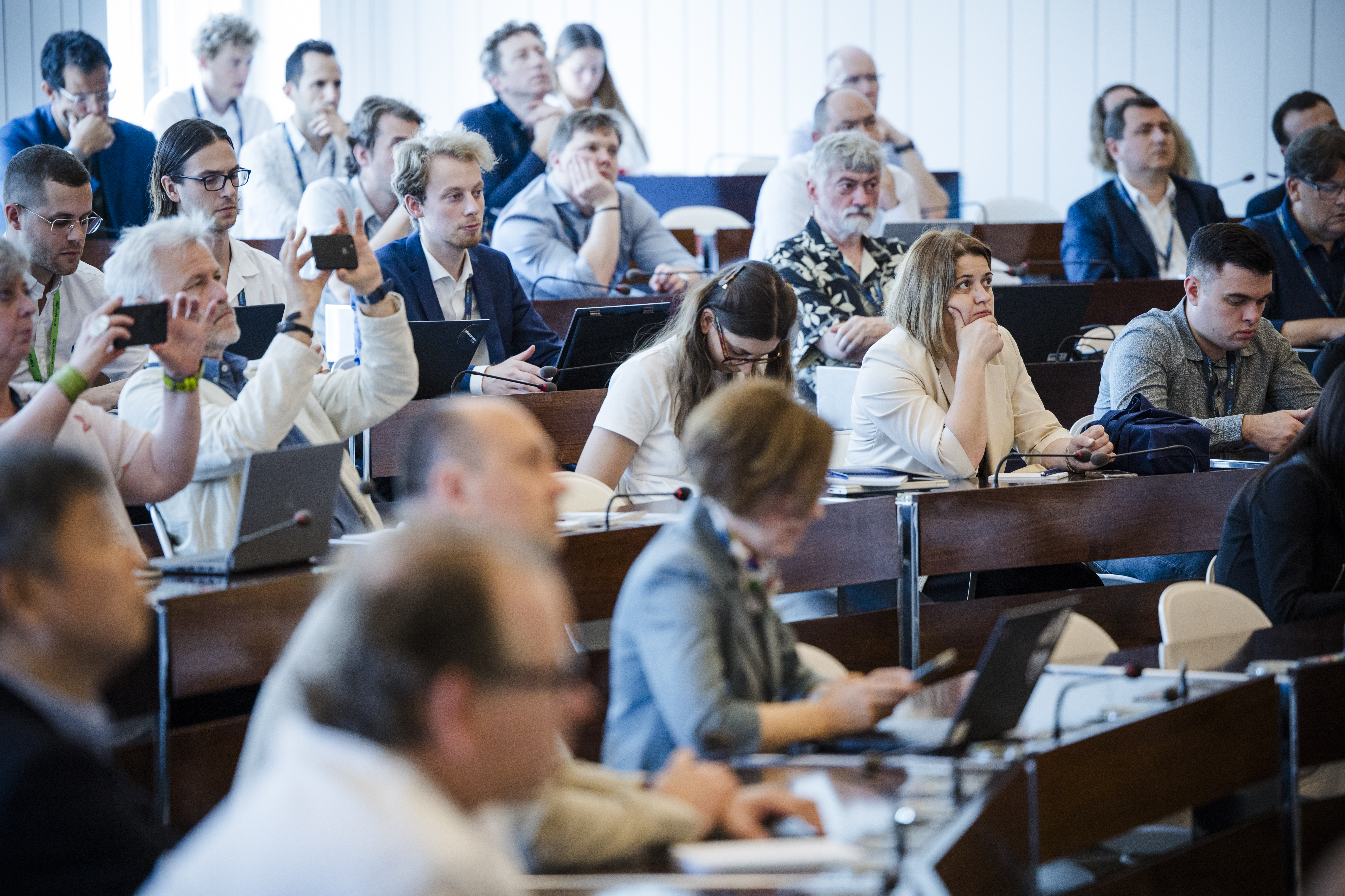A small audinece of people listening and interacting with a presentor at the SEMIC workshops 2024.