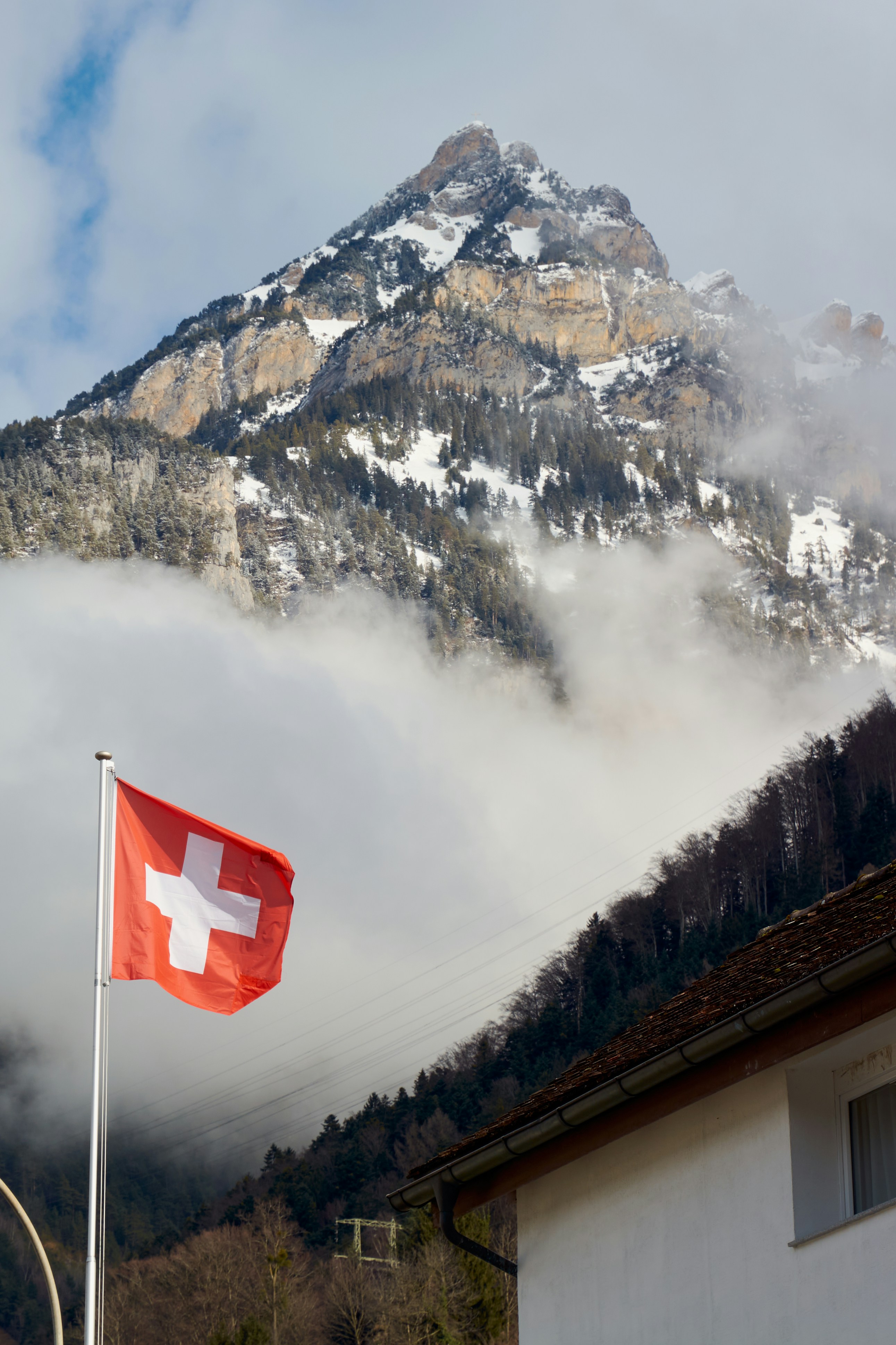 oksana burki unsplash- swiss flag and mountains
