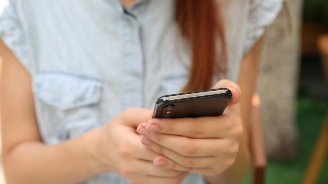 A woman holding her phone